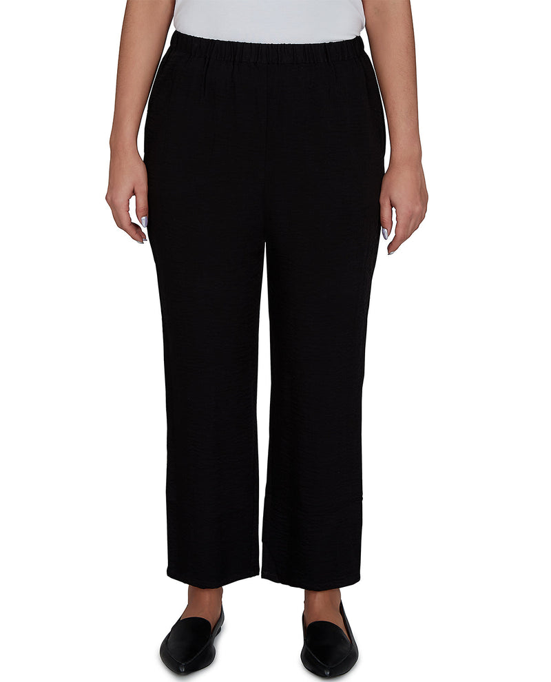 Person wearing black pants on a white background