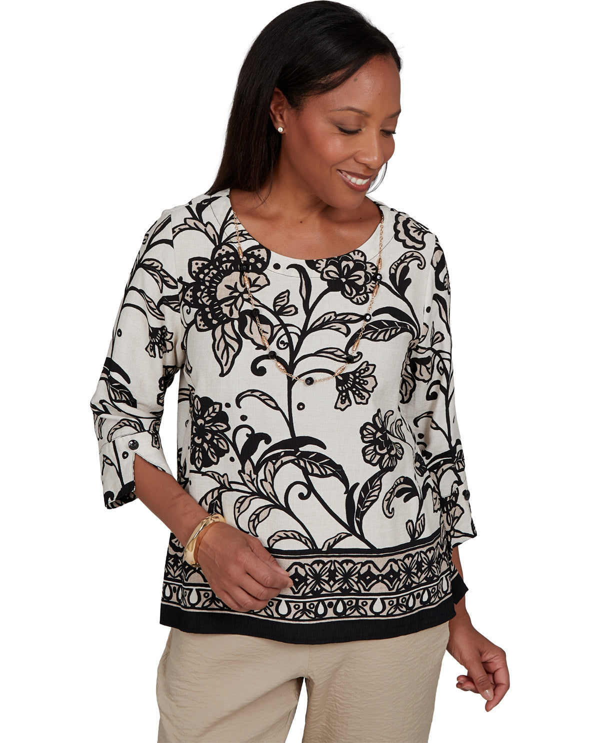 Woman wearing a black and white floral patterned top on a white background