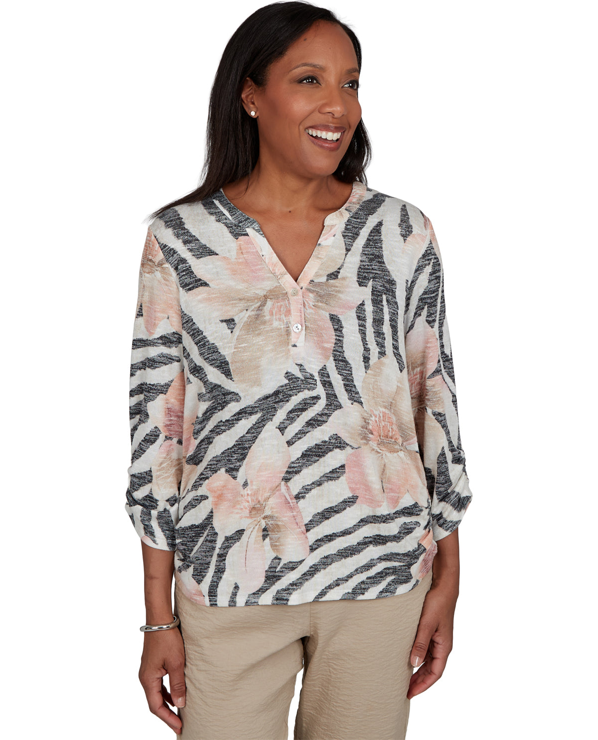 Woman wearing a floral and zebra print blouse on a white background