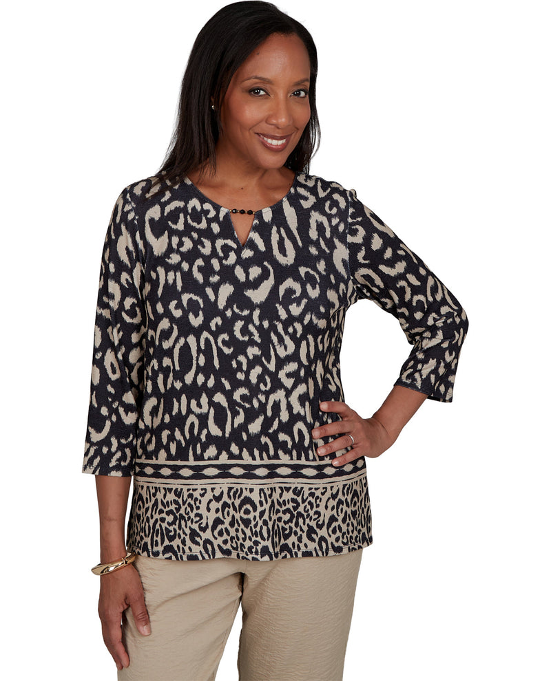 Woman wearing a leopard print top on a white background