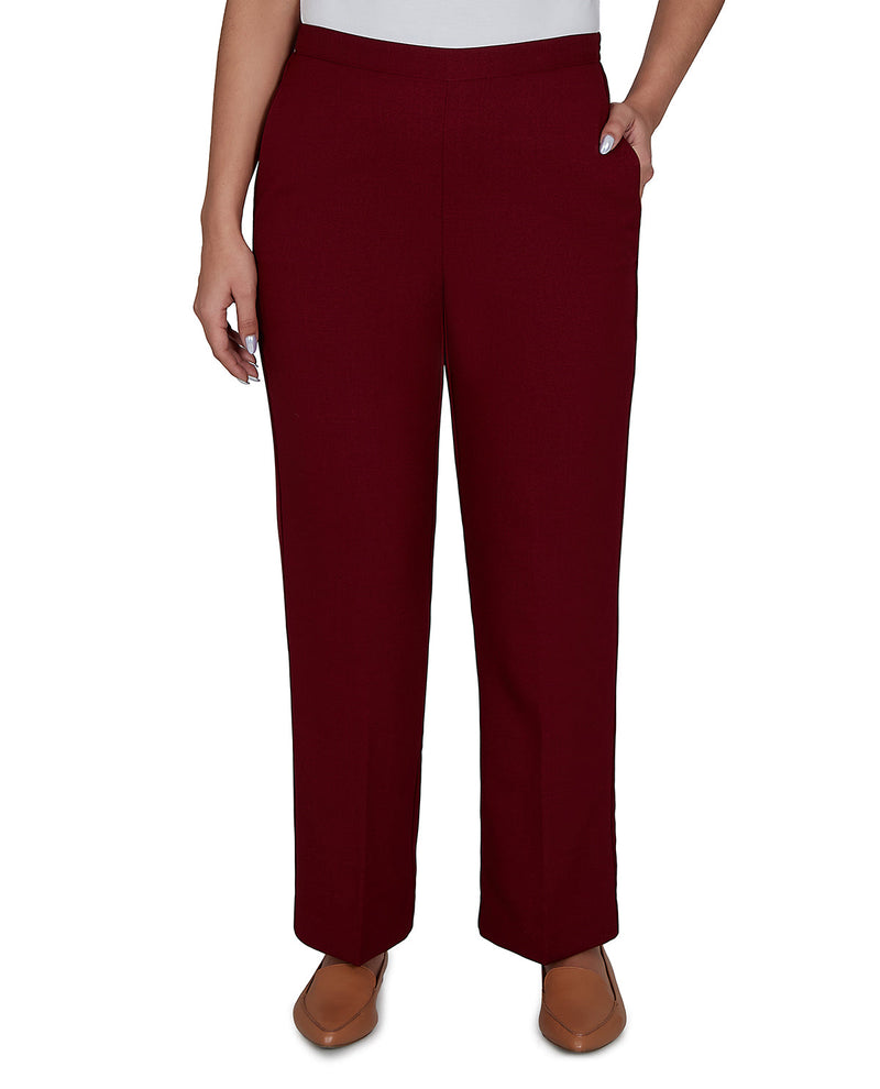 Maroon pants worn by a person on a white background