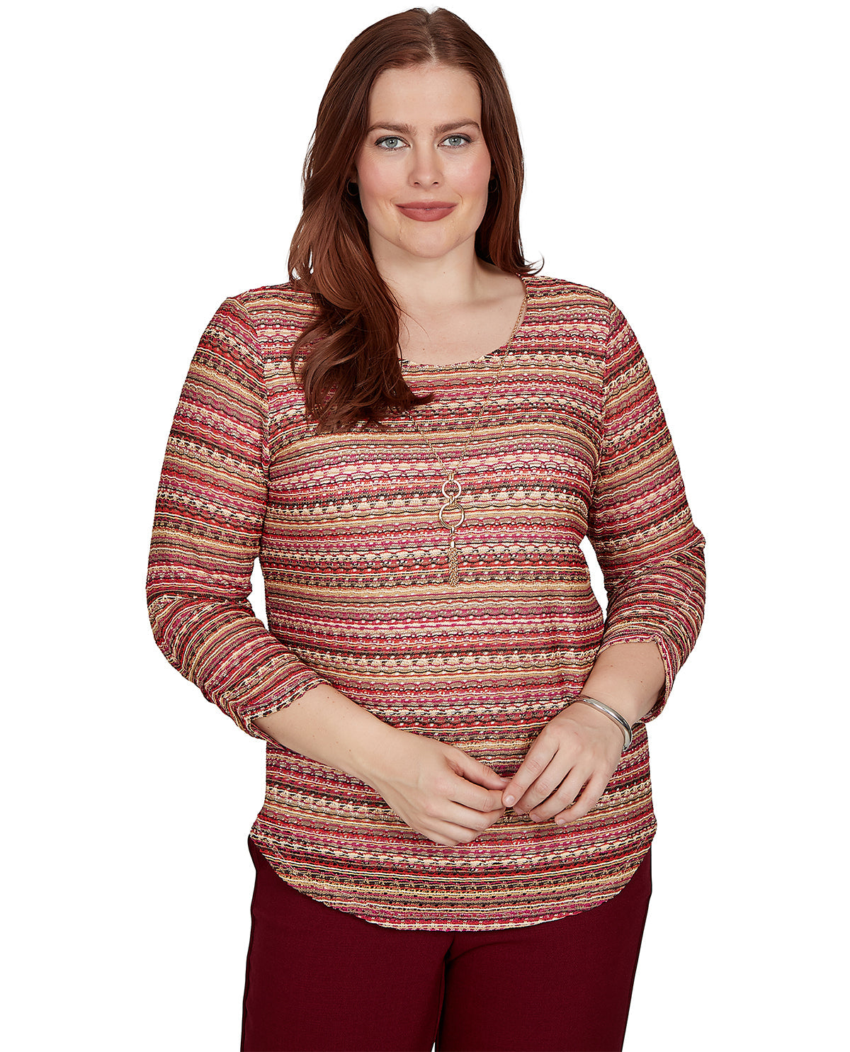 Woman wearing a patterned long-sleeve top on a white background