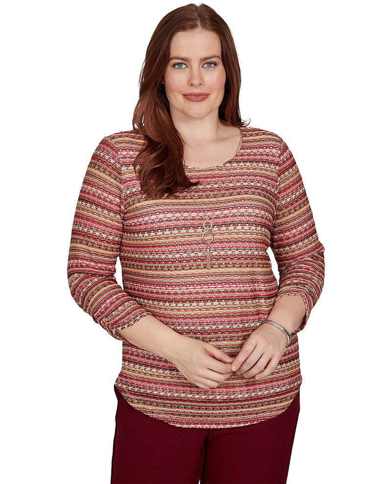 Woman wearing a patterned long-sleeve top on a white background