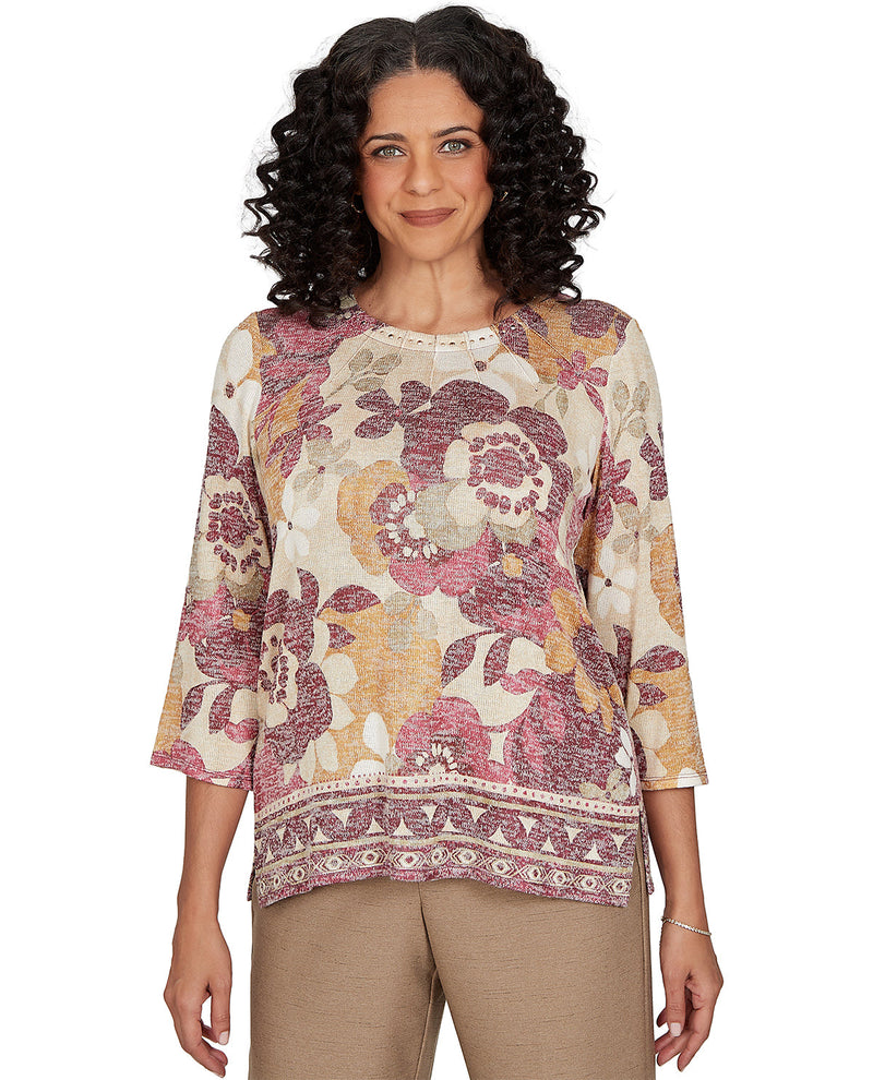Woman wearing a floral patterned top on a white background