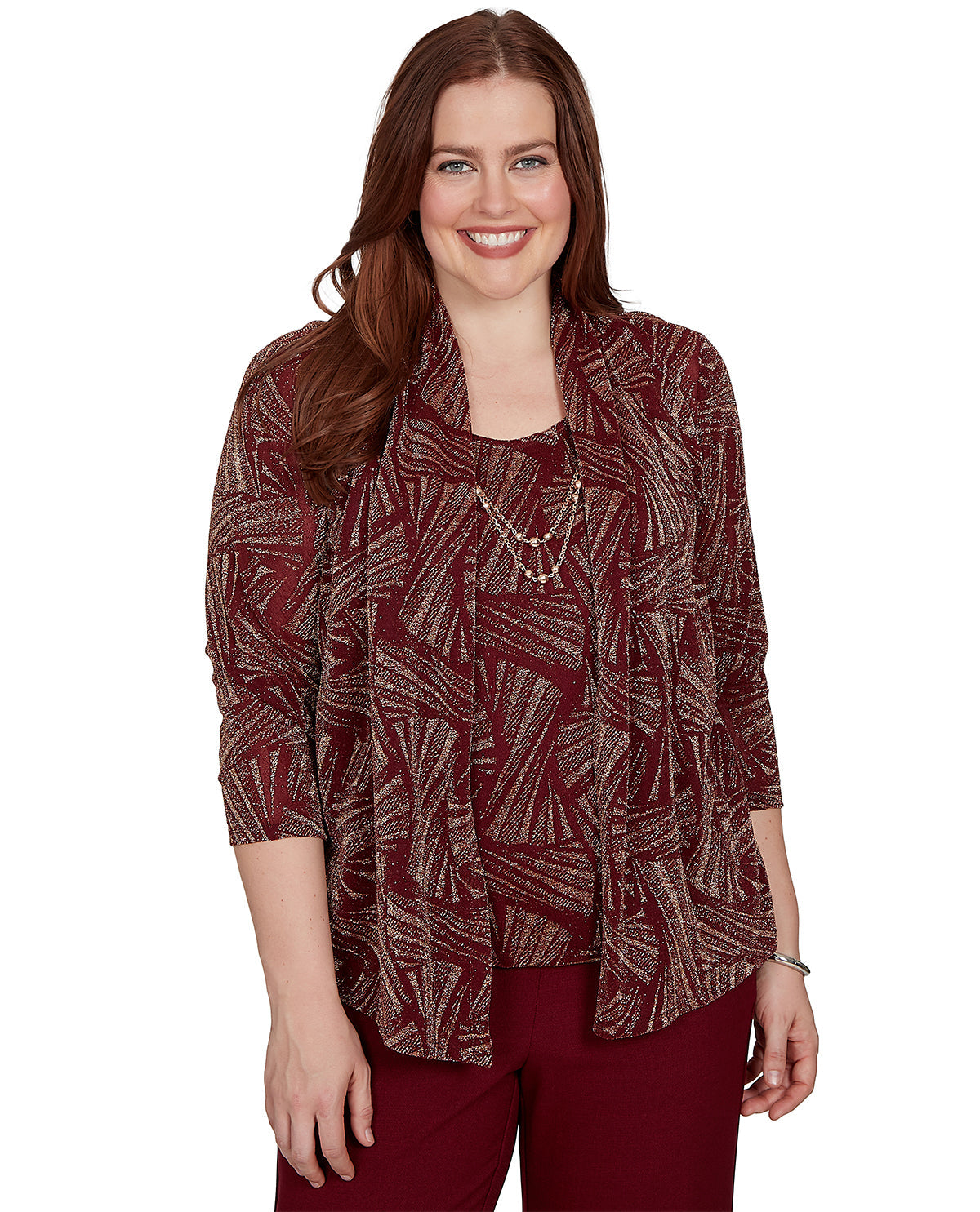 Woman wearing a patterned jacket and red pants on a white background