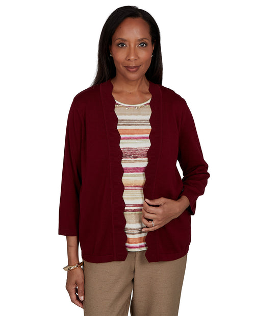 Woman wearing a burgundy cardigan over a striped shirt on a white background