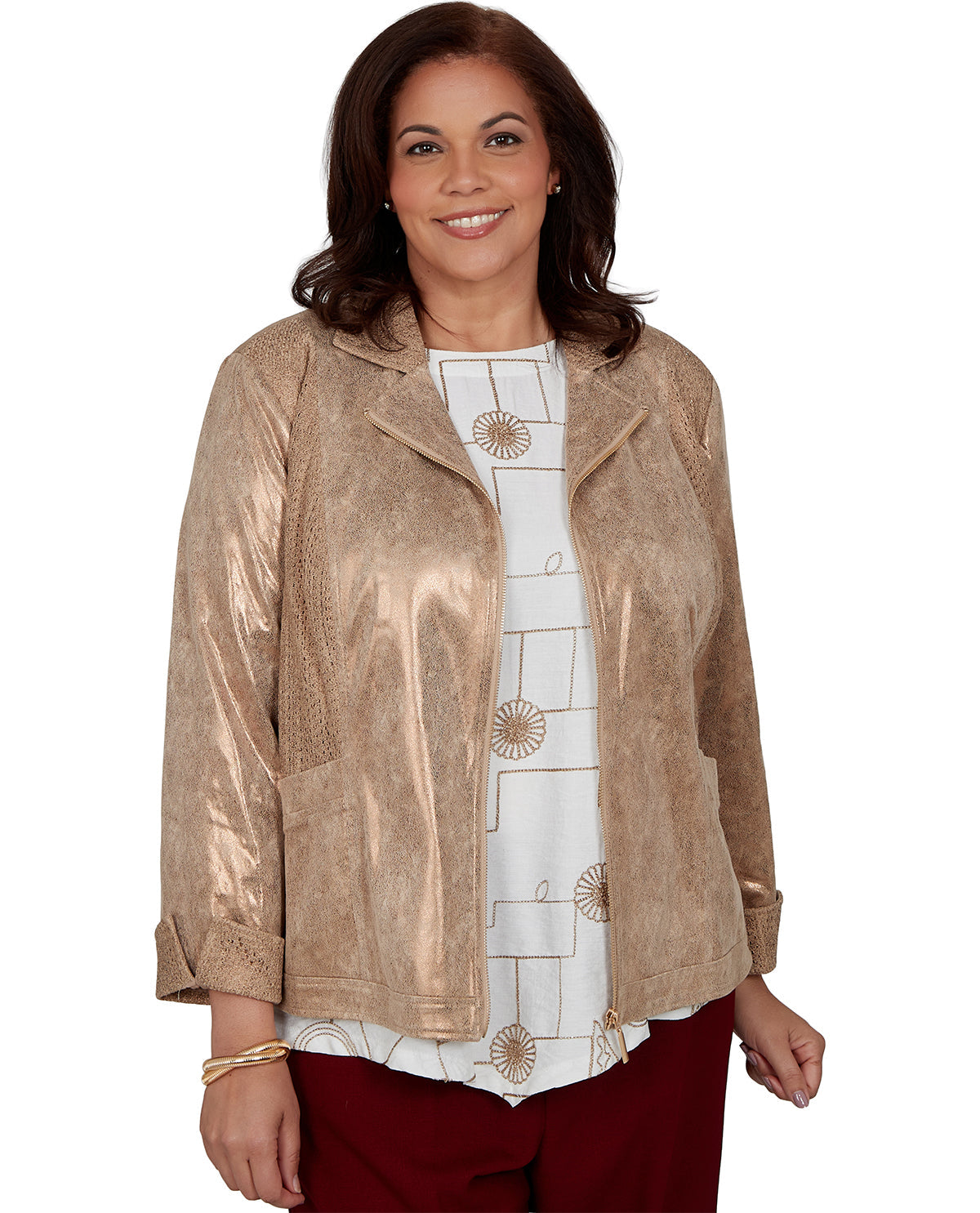 A woman wearing a metallic champagne beige jacket over a white patterned top and burgundy pants, photographed against a plain white background.