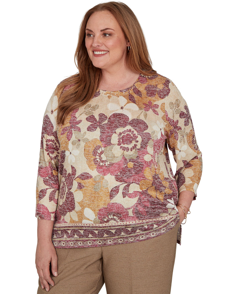 Woman wearing a floral patterned top on a white background