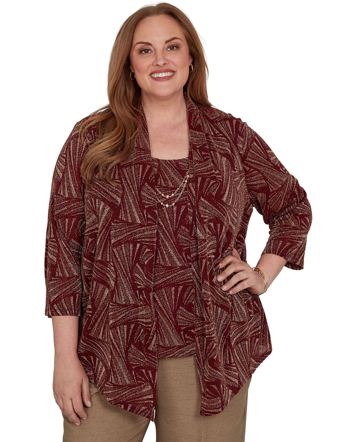 Woman wearing a patterned maroon top on a white background