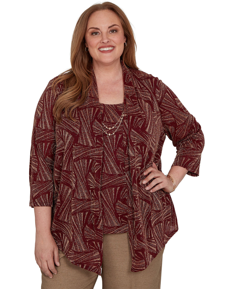 Woman wearing a patterned maroon top on a white background