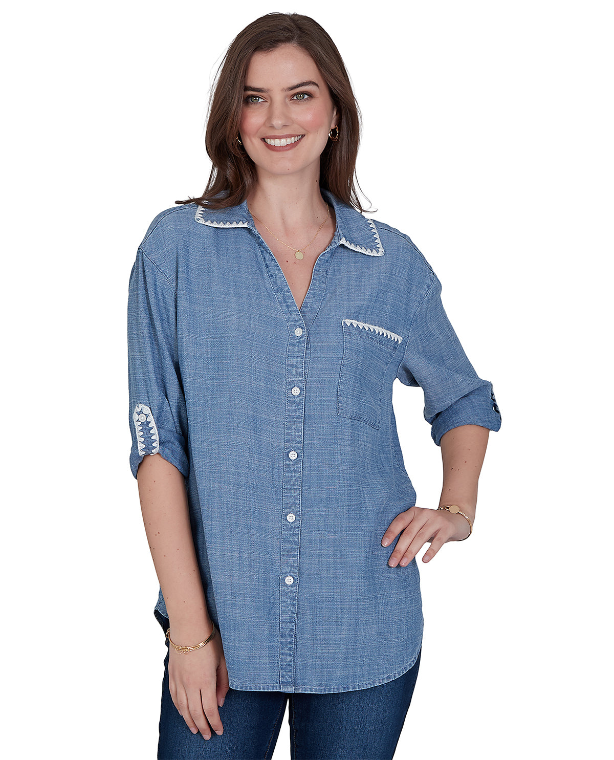 Woman wearing a blue denim shirt with white trim on a white background