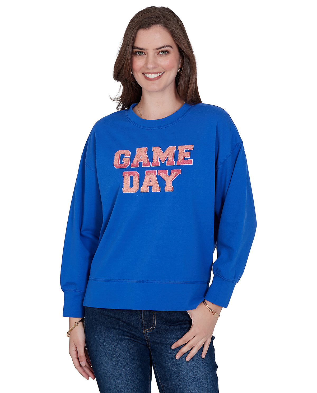 Woman wearing a blue sweatshirt with 'GAME DAY' text on a white background
