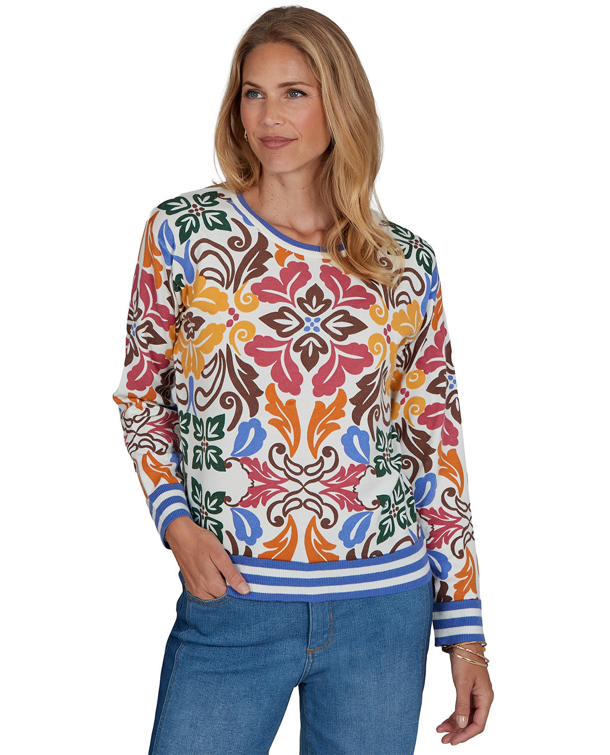 Woman wearing a colorful patterned sweater on a white background
