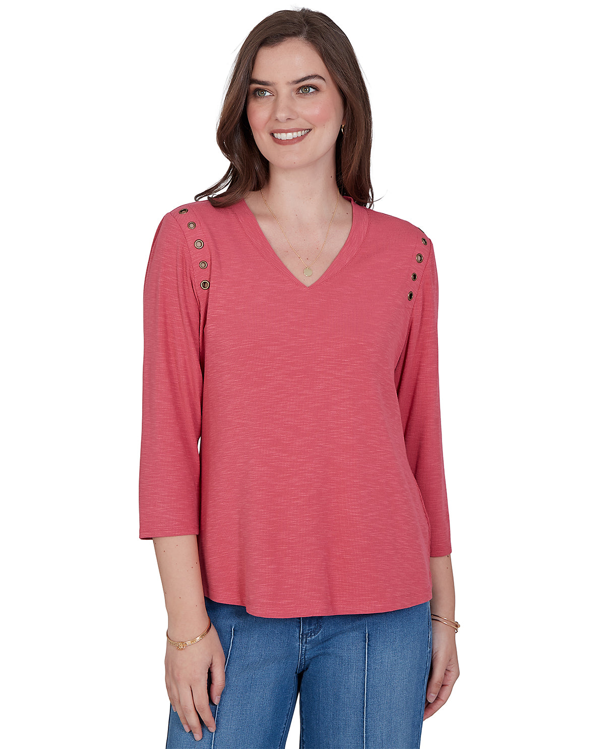Woman wearing a pink long-sleeve top with button details on a white background
