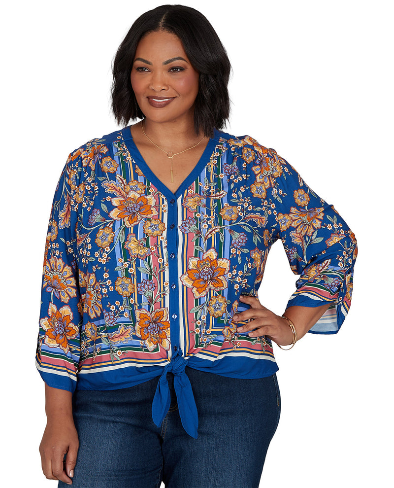 Woman wearing a blue floral blouse with a white background