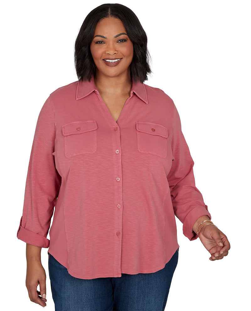 Woman wearing a pink button-up shirt on a white background