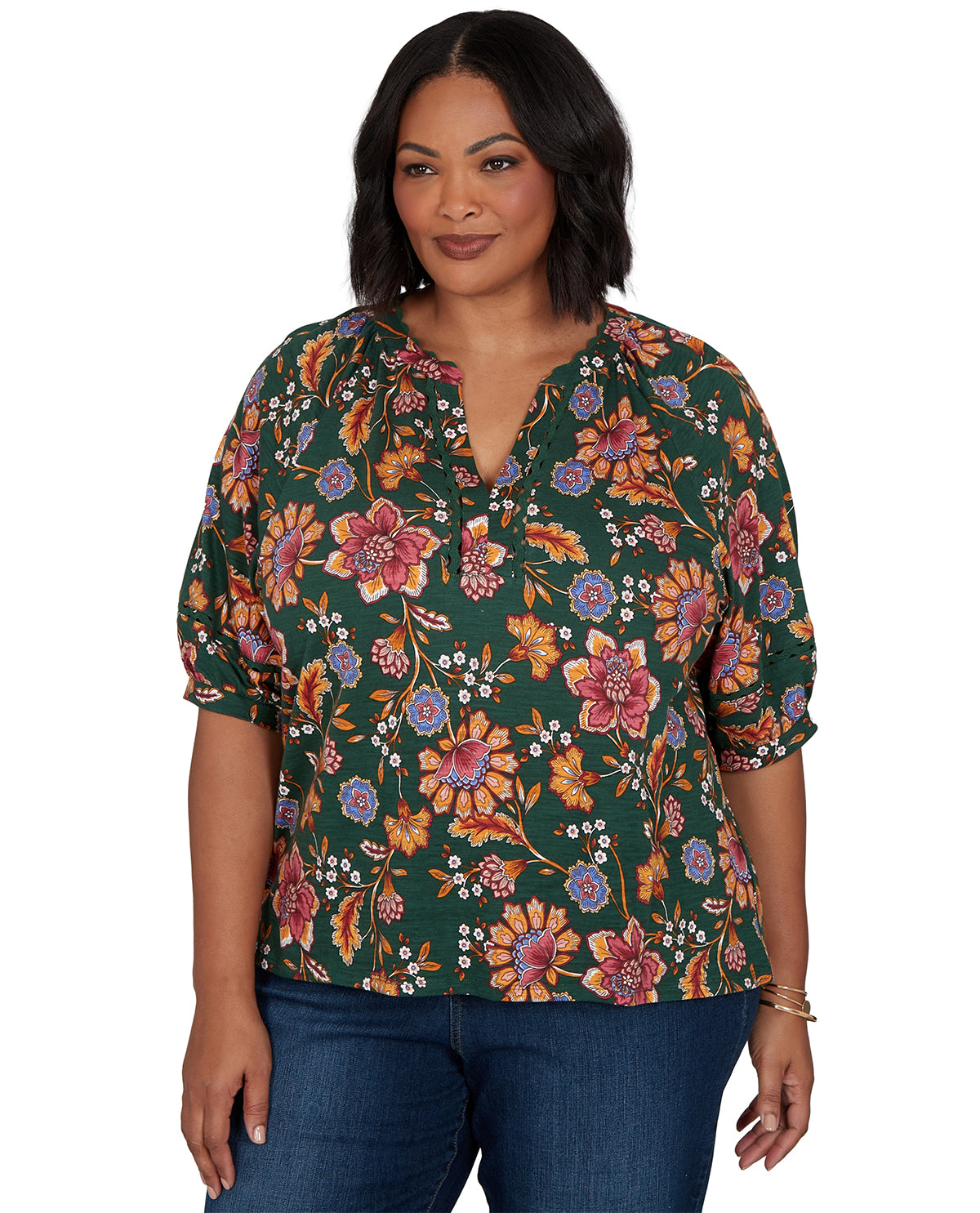 Woman wearing a floral blouse with a green background