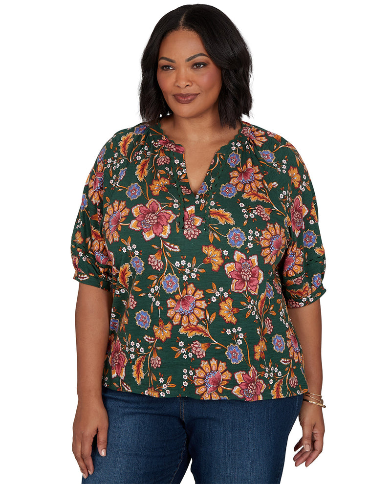 Woman wearing a floral blouse with a green background