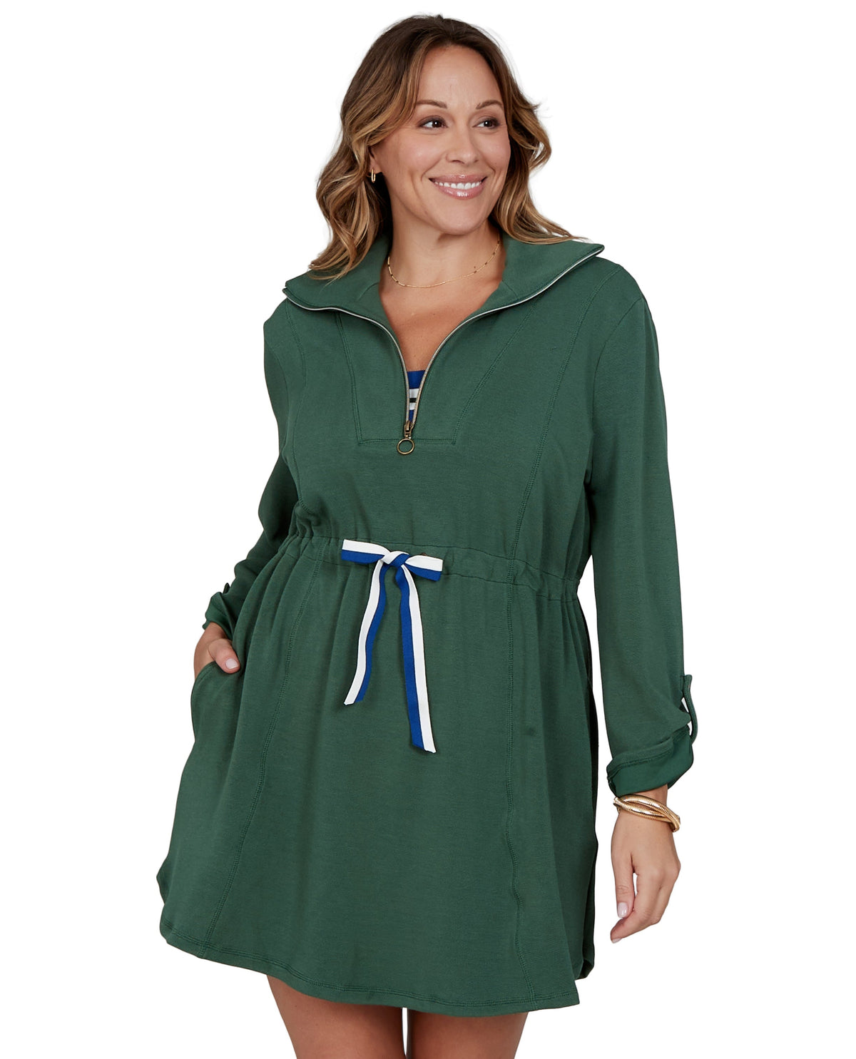 Woman wearing a green dress with a white and blue ribbon on a white background