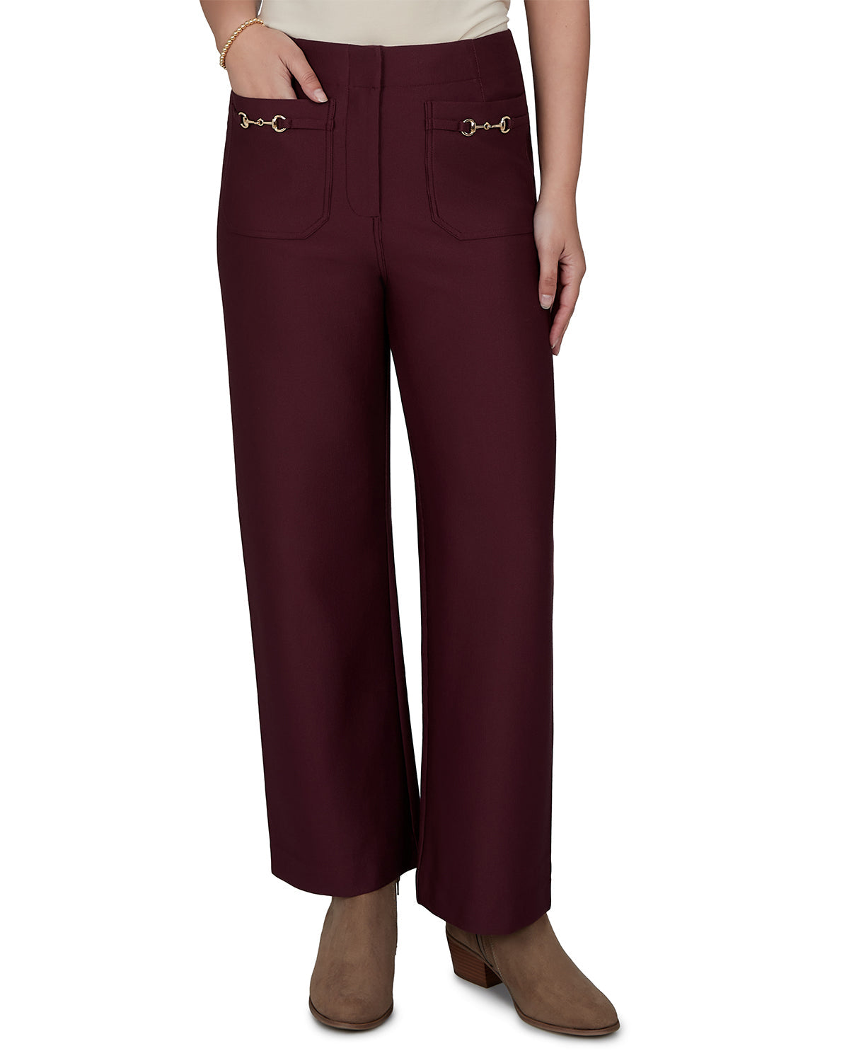 Maroon pants with decorative buttons worn by a person on a white background