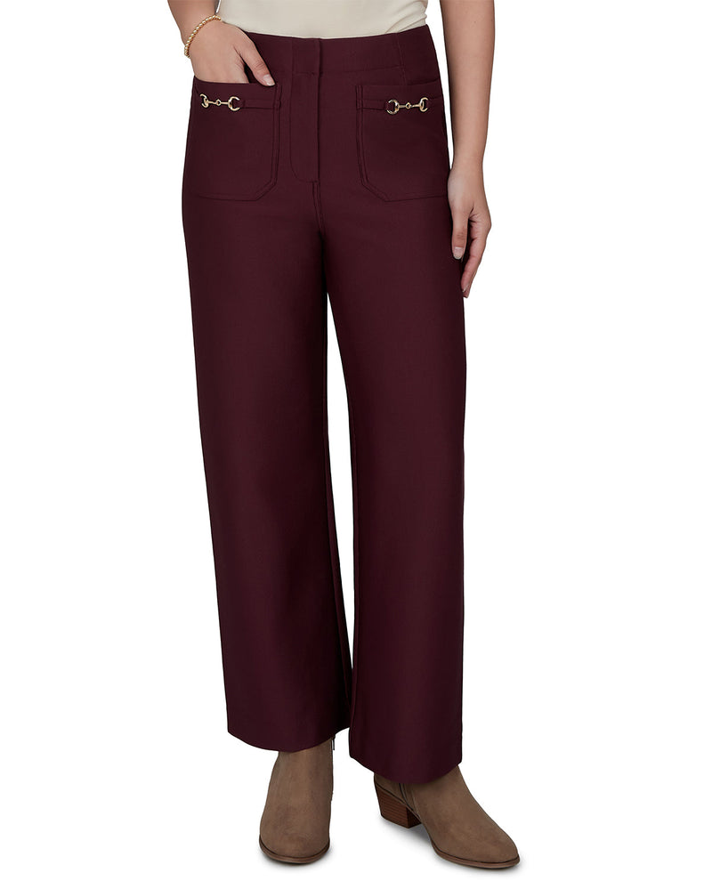 Maroon pants with decorative buttons worn by a person on a white background