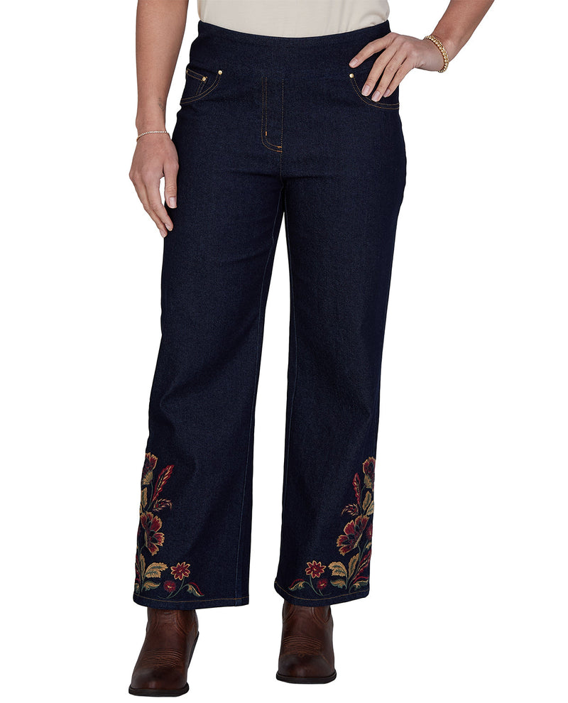 Navy blue jeans with floral embroidery on a white background