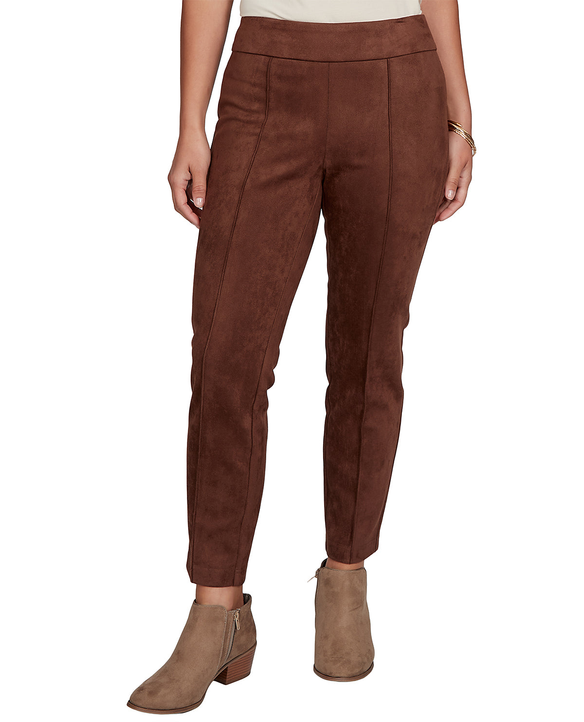 Brown suede pants worn by a person on a white background