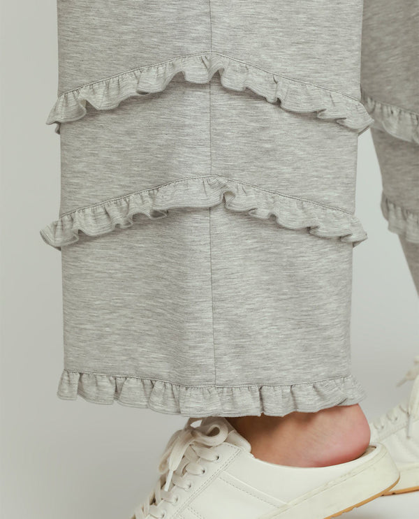 Gray ruffled skirt worn by a person on a plain background