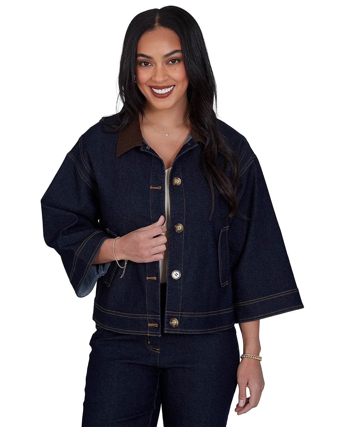 Woman wearing a dark denim jacket on a white background