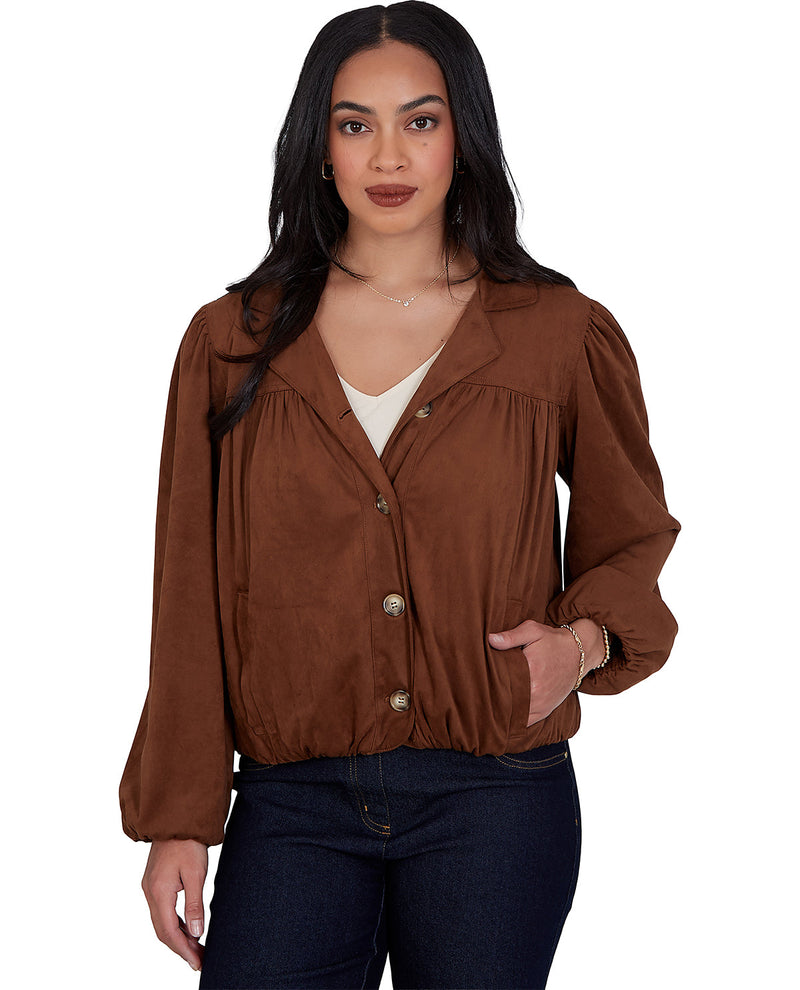 A woman modeling a brown long-sleeve button-up jacket with a relaxed fit, gathered waist, and gold-tone buttons, paired with dark blue jeans against a plain white background.