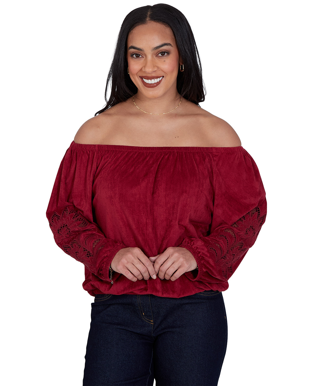 Woman wearing a red off-shoulder top with lace details on a white background