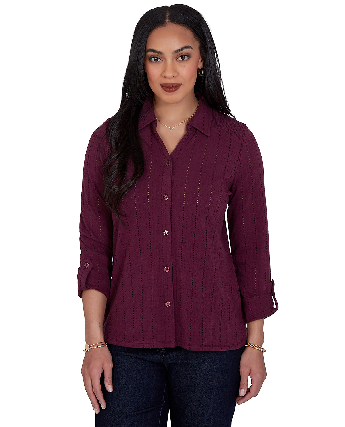 Woman wearing a burgundy button-up shirt on a white background