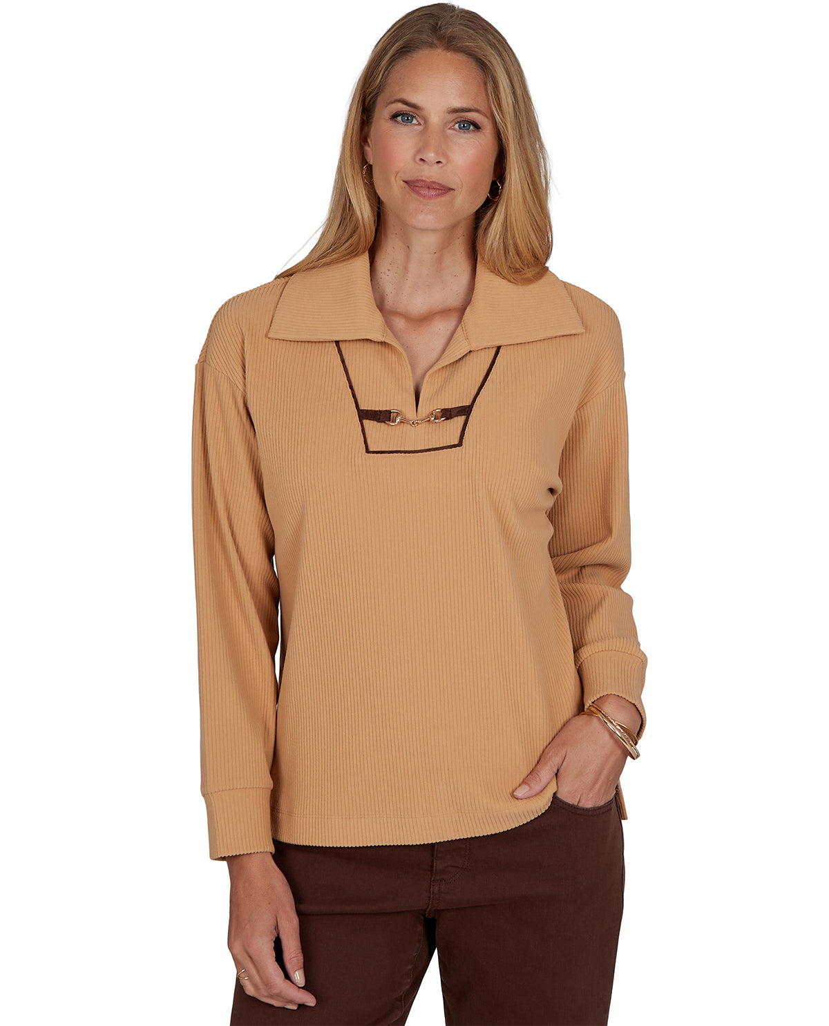 Woman wearing a beige long-sleeve shirt with a collar on a white background