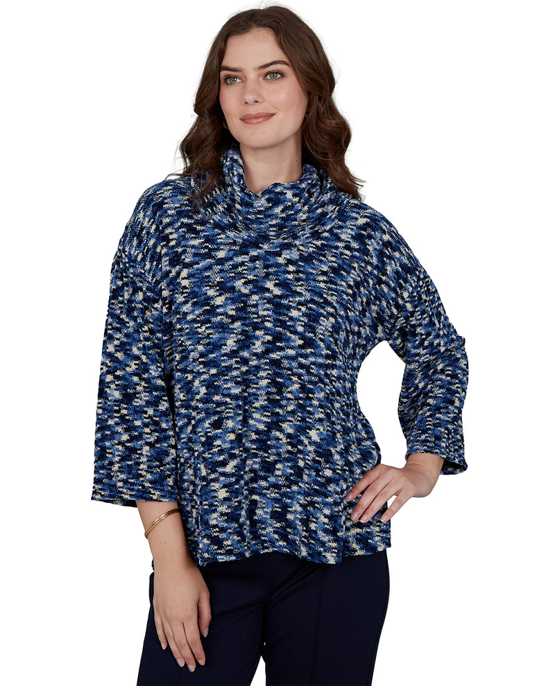 Woman wearing a blue and white patterned sweater on a white background