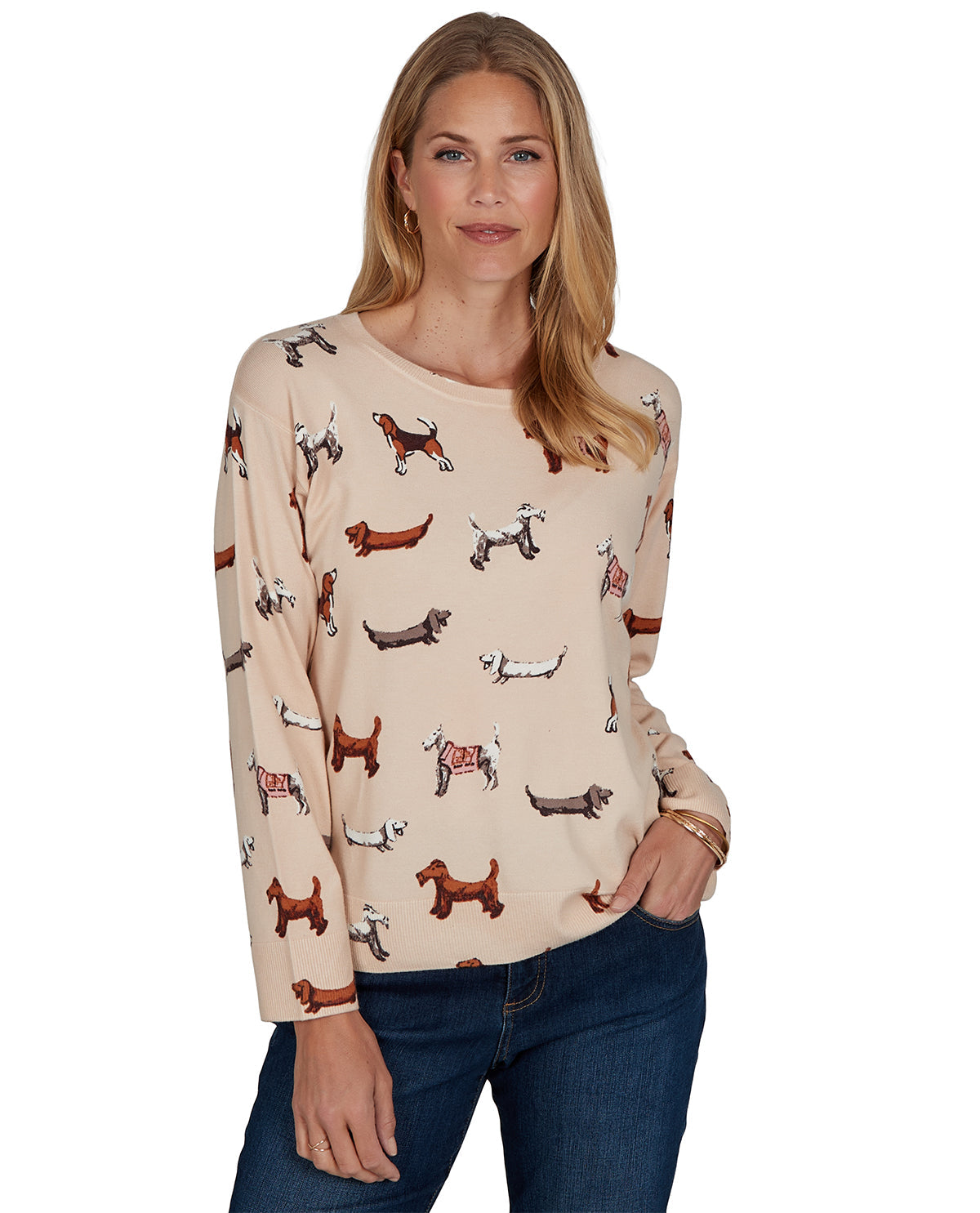 Woman wearing a beige sweater with dog pattern on a white background