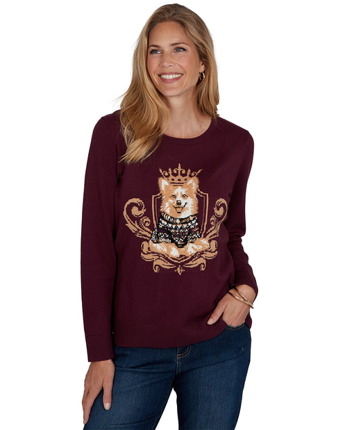 Woman wearing a burgundy sweater with a dog design on a white background