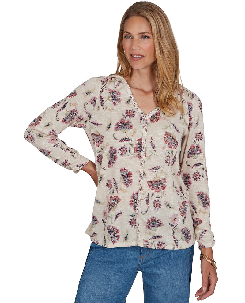 Woman wearing a floral blouse with a white background