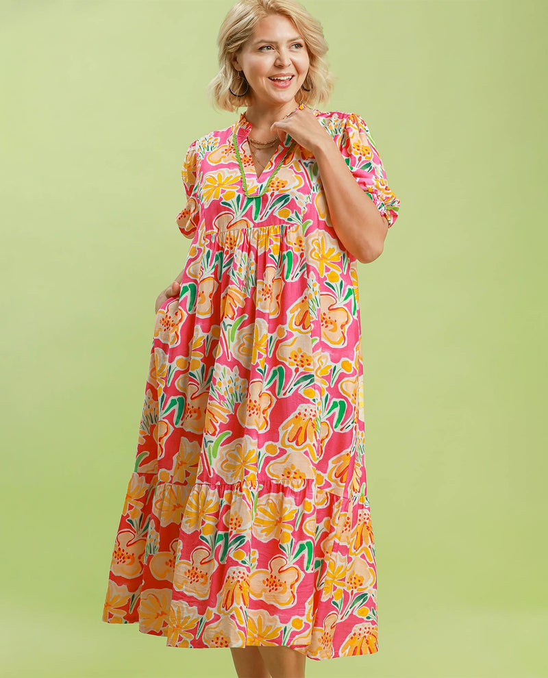 Woman wearing a colorful floral dress on a light green background