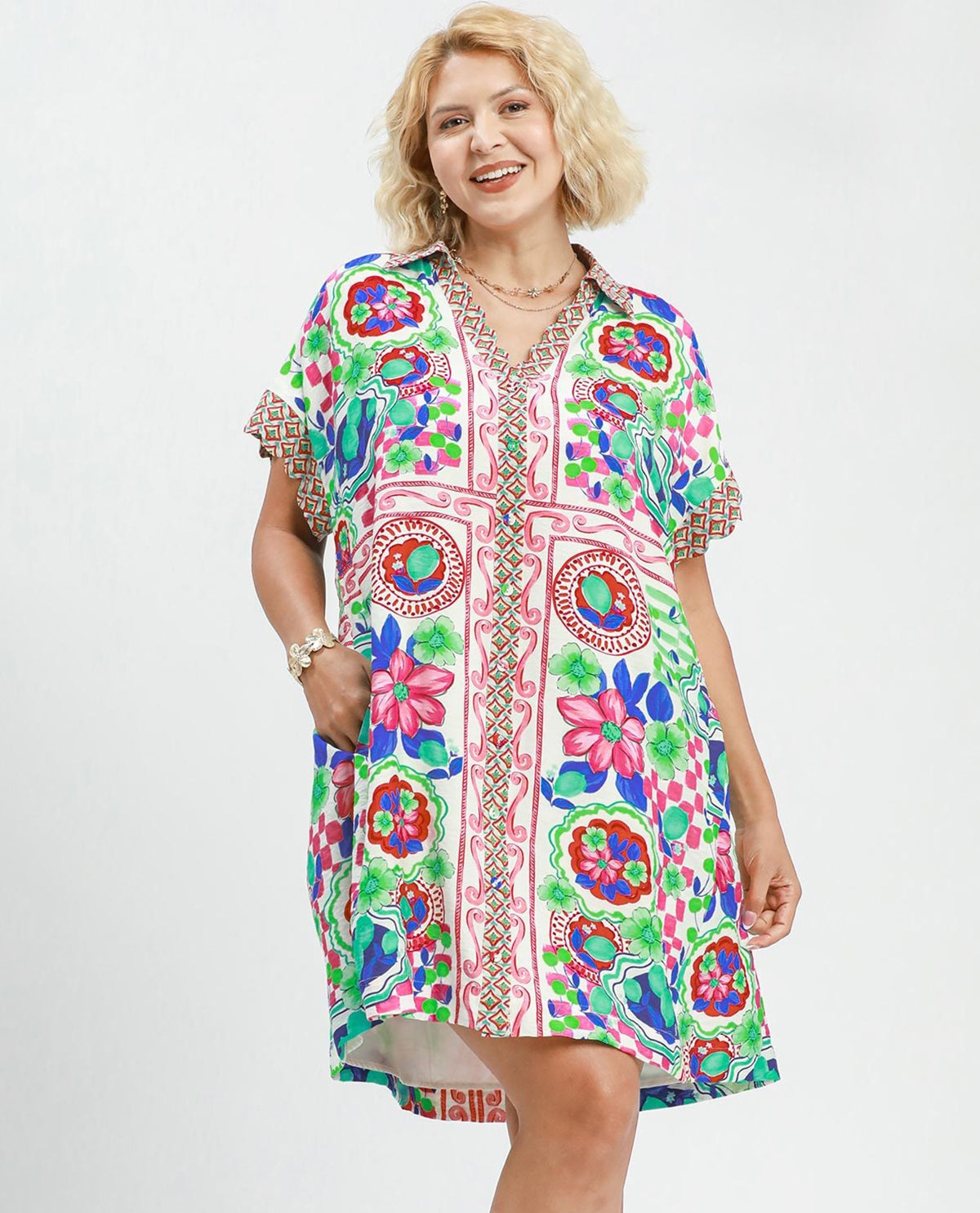 Woman wearing a colorful patterned dress on a white background