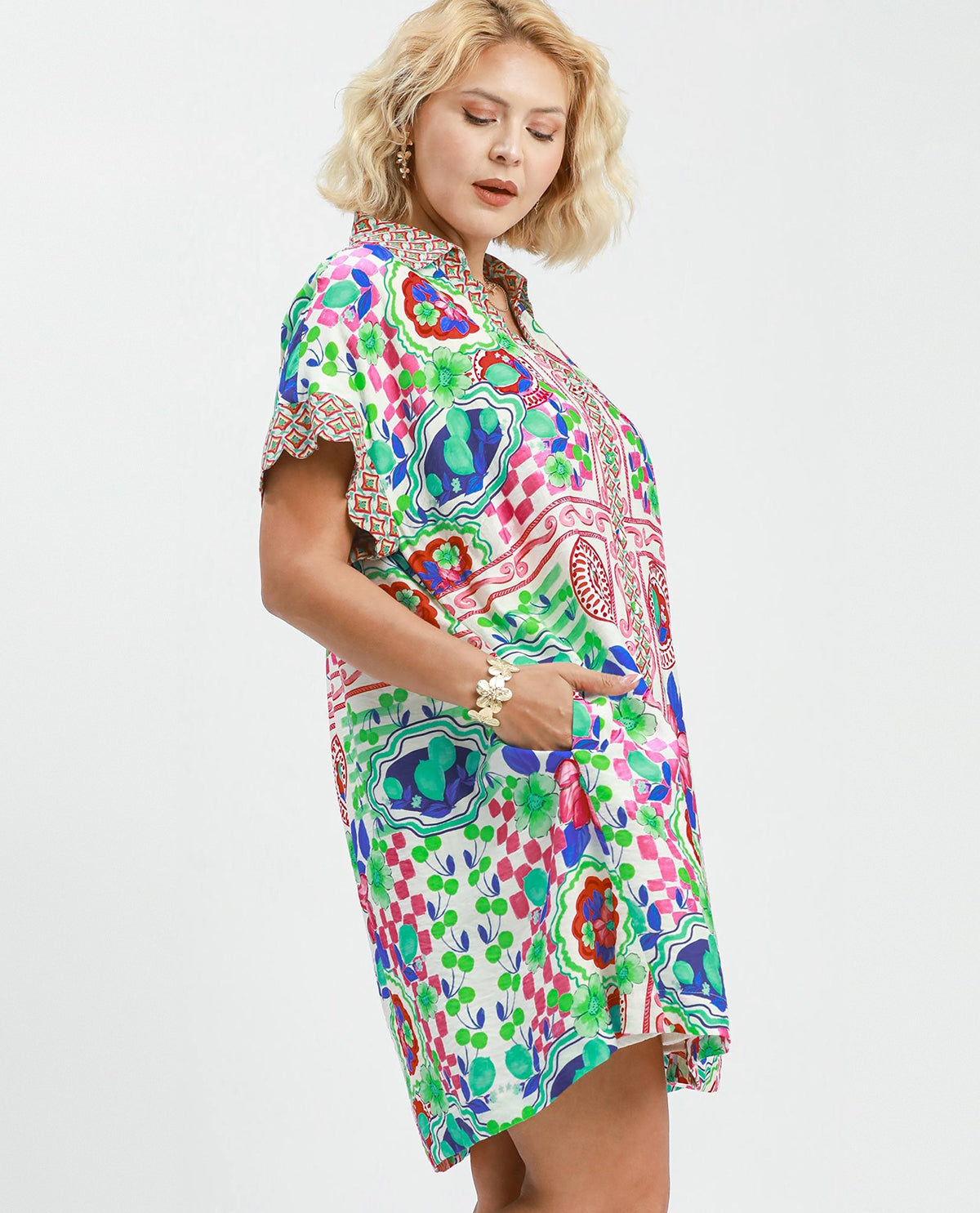 Woman wearing a colorful patterned dress on a white background