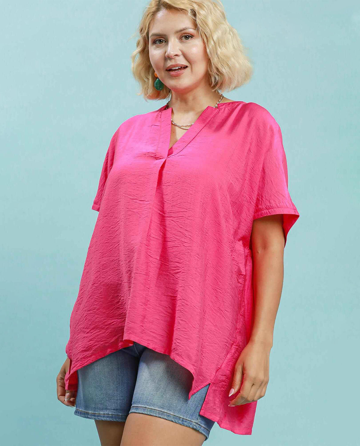 Woman model wearing a solid hot pink oversized top