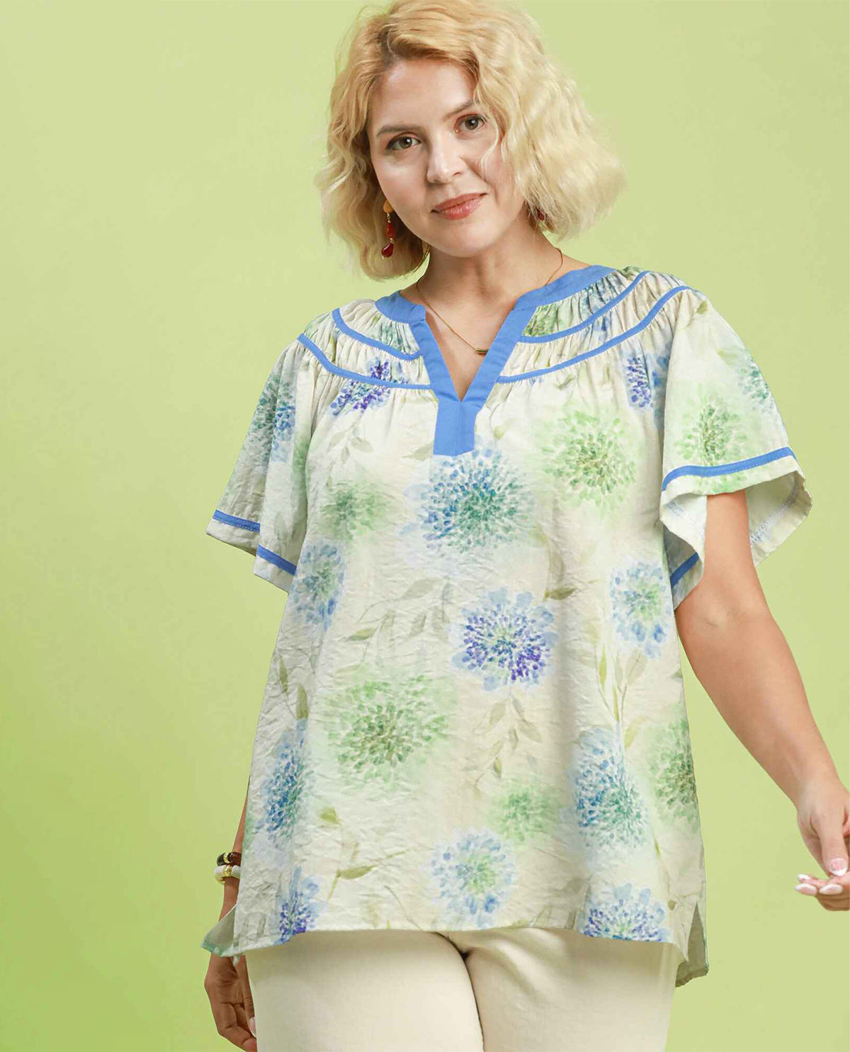 Woman model wearing a short sleeve floral blue blouse