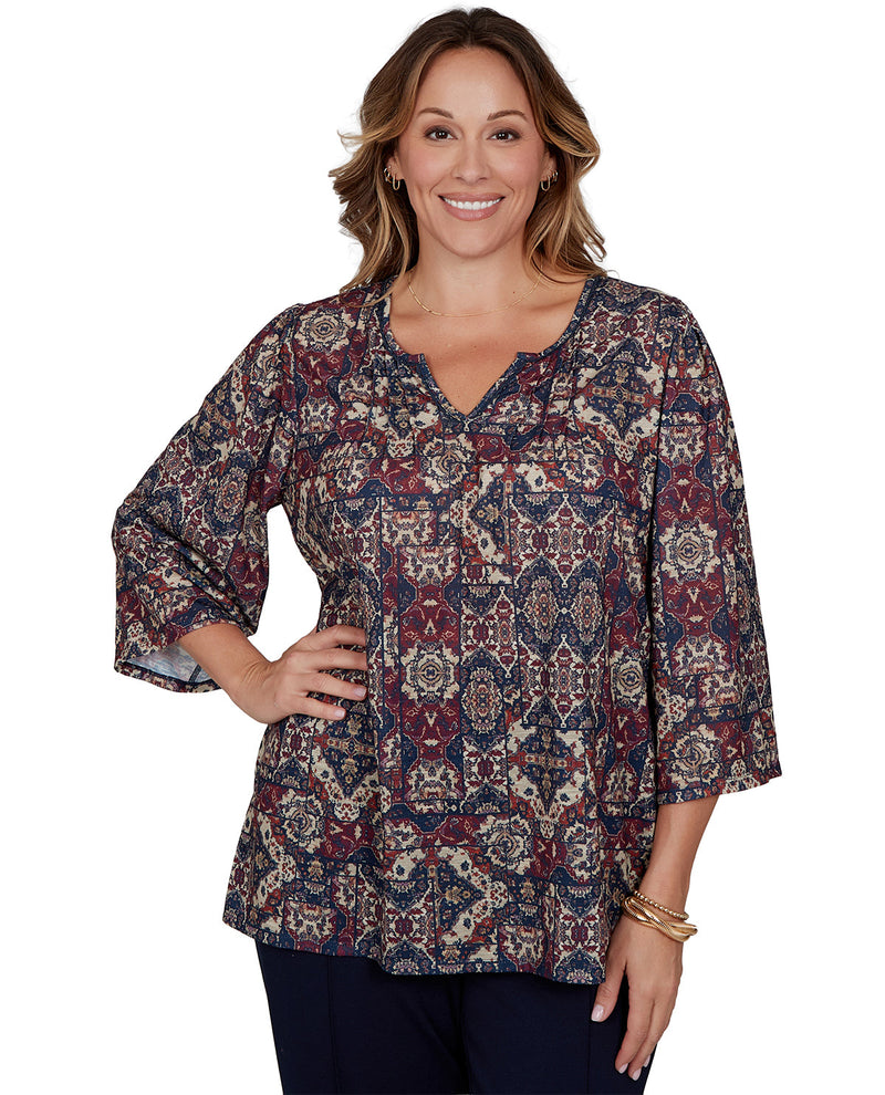 Woman wearing a patterned blouse on a white background