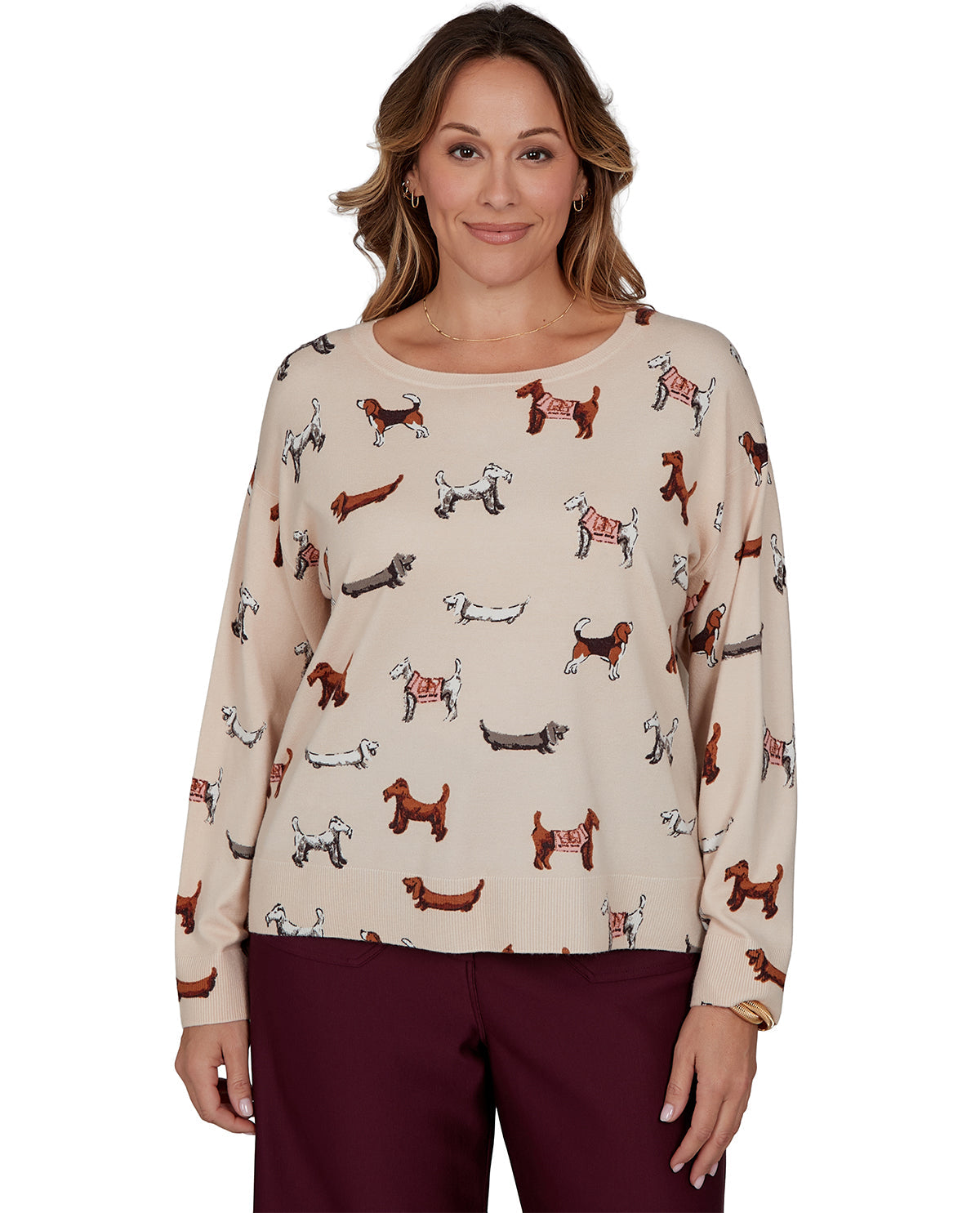 Woman wearing a beige long-sleeve top with dog pattern on a white background