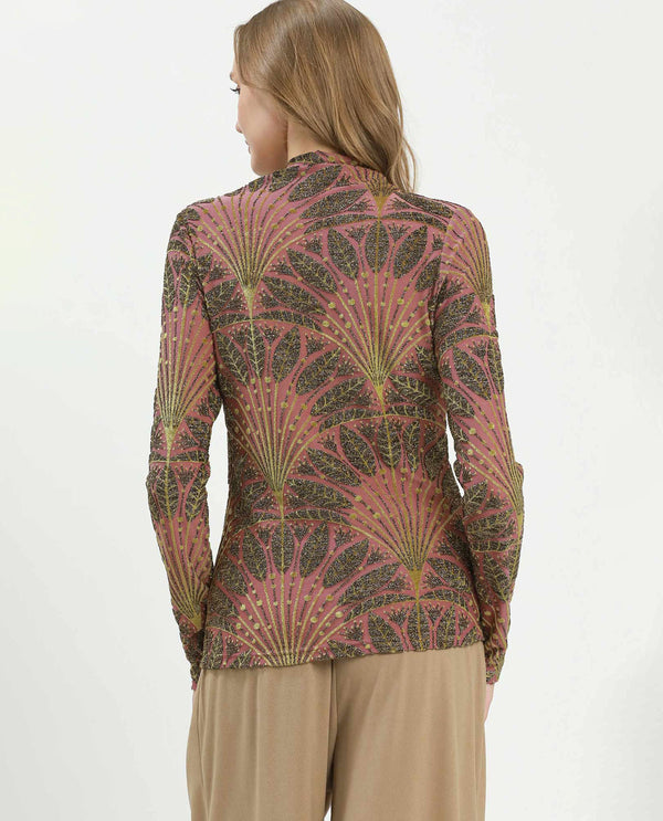 Woman wearing a patterned long-sleeve top on a white background