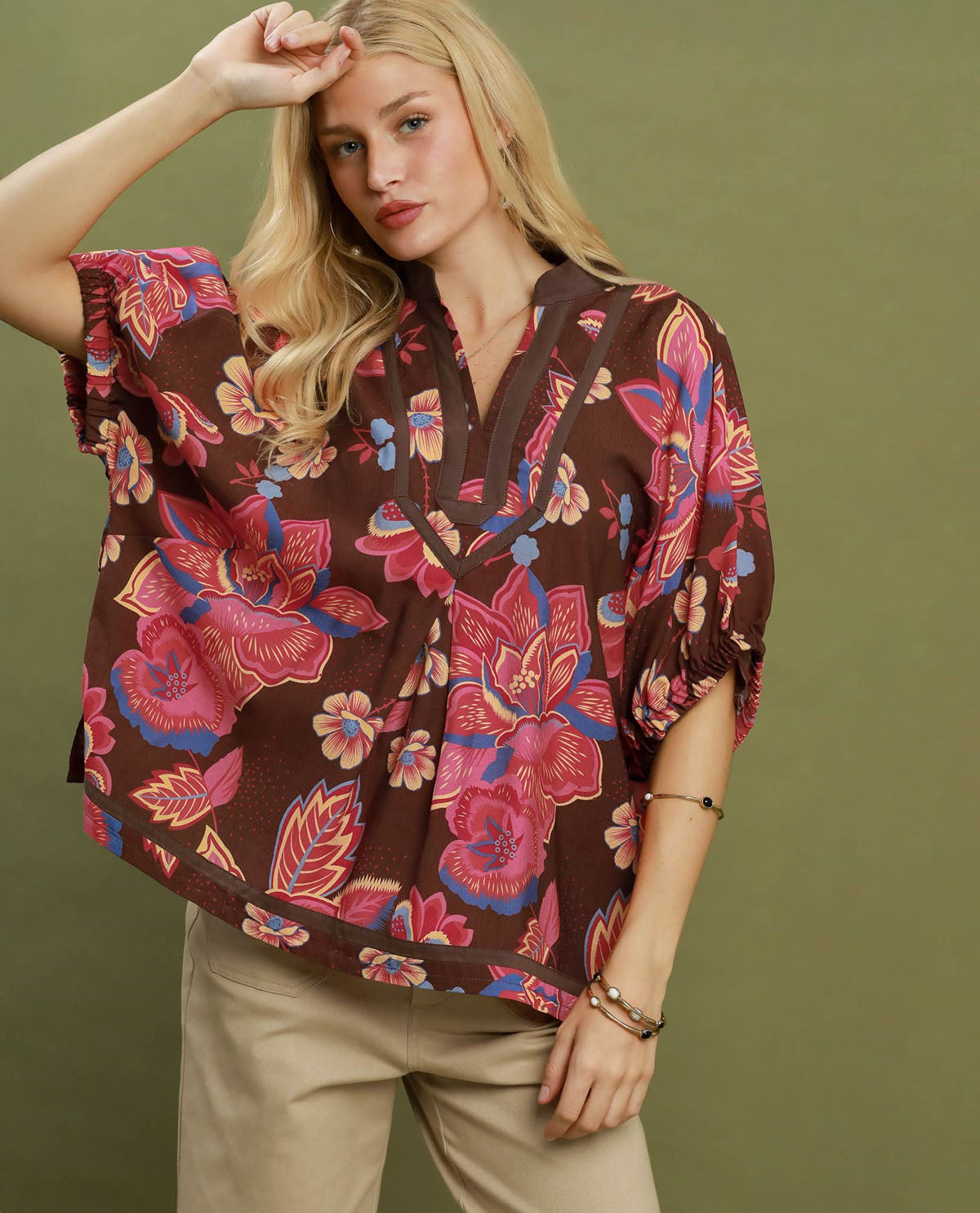 Woman wearing a floral blouse with a green background