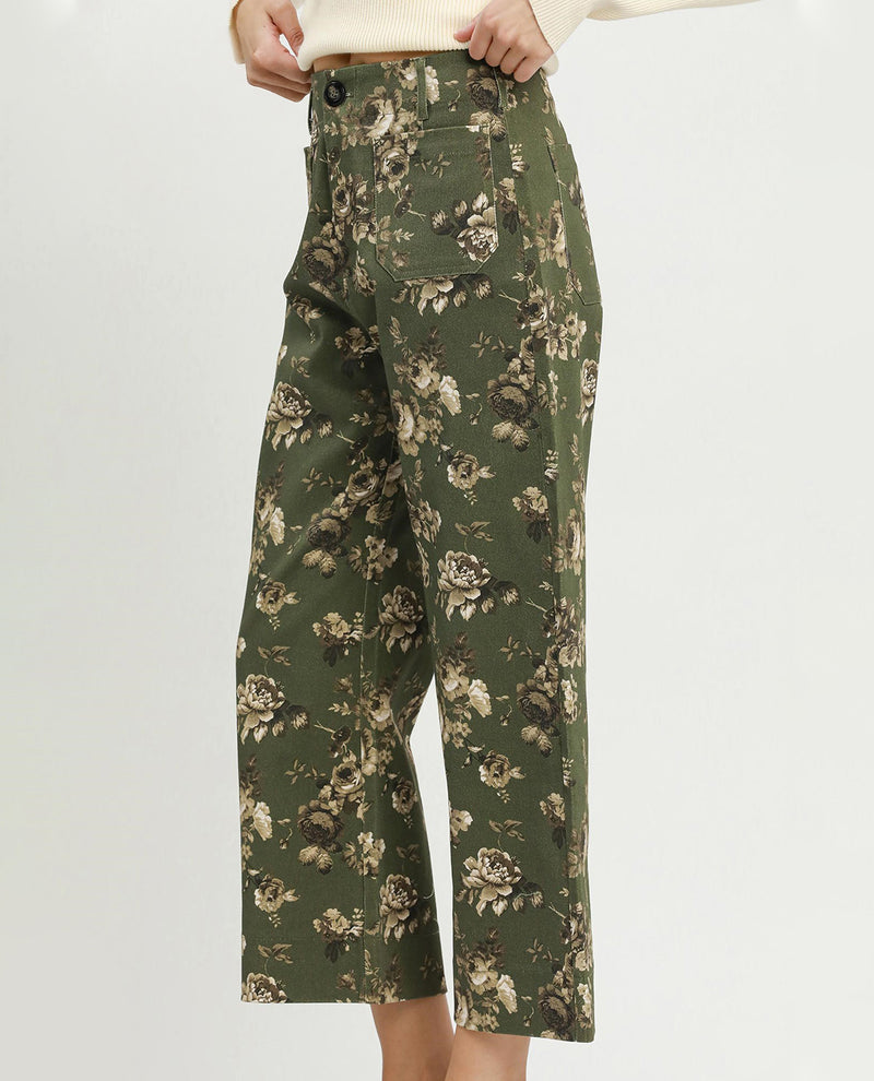 Green floral-patterned pants on a white background