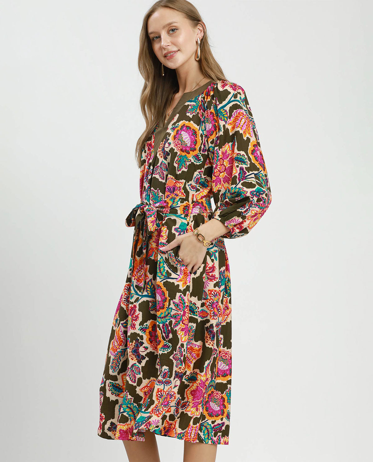Woman wearing a colorful floral dress on a white background