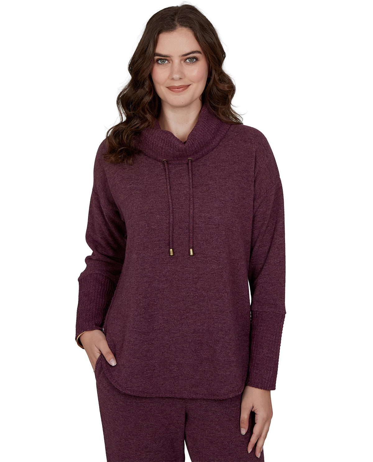 Woman wearing a maroon hoodie and pants on a white background