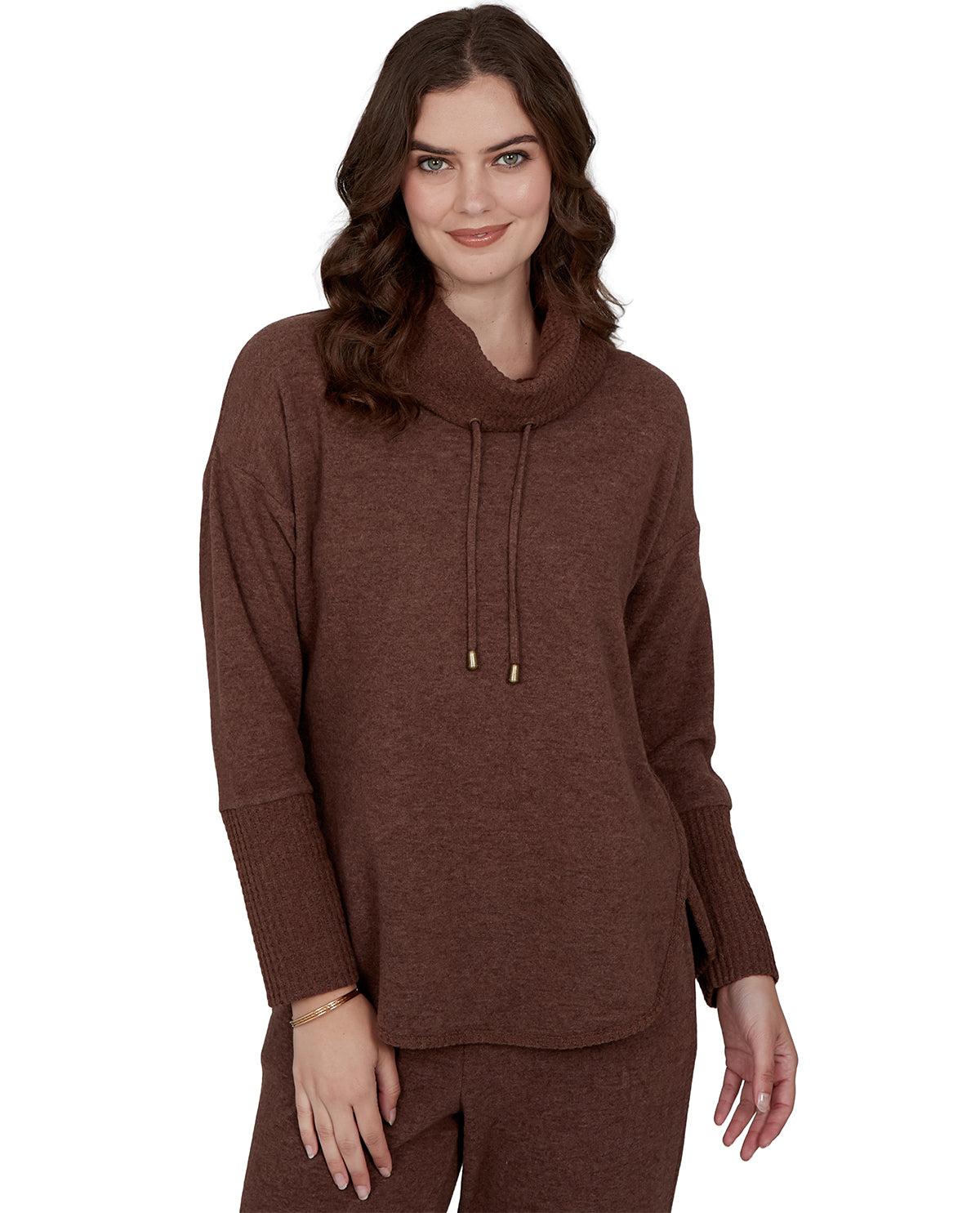 Woman wearing a petite brown hoodie and pants on a white background